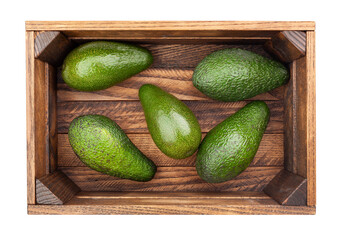 avocado in wooden box path isolated on white top view