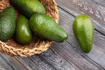 avocado in a basket on wood background