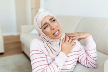 Pain in the shoulder. Upper arm pain, Arabic muslim woman with body-muscles problem, Healthcare And...