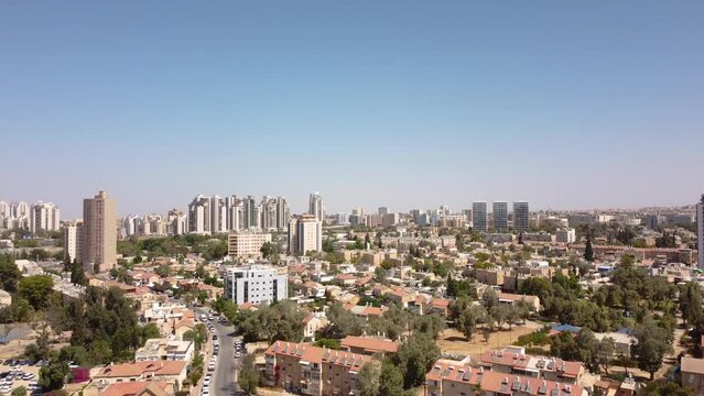 Straight flight over residential district of Beer Sheba city at hot summer morning