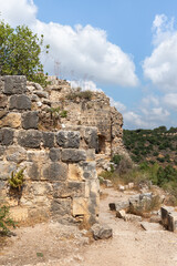 Fototapeta na wymiar The ruins of the Monfort fortress are located on a high hill overgrown with forest, not far from Shlomi city, in the Galilee, in northern Israel