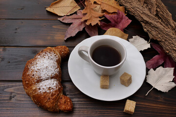 Cornetto e caffè a colazione in autunno