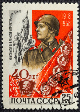 RUSSIA - CIRCA 1958: stamp printed in USSR CCCP, soviet shows man in uniform his family in world war II. 40th anniversary young communist league Komsomol Scott 2137 A1116 25k red circa 1958