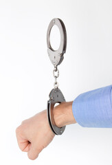hand buckled in handcuffs, on an isolated white background