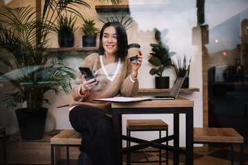 Young millennial asian businesswoman work in cafe