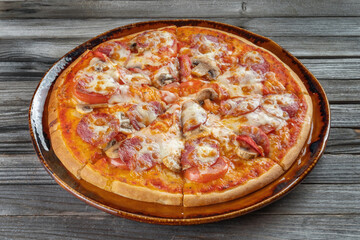 Slices of pizza with mushrooms, cheese and tomatoes on a plate.