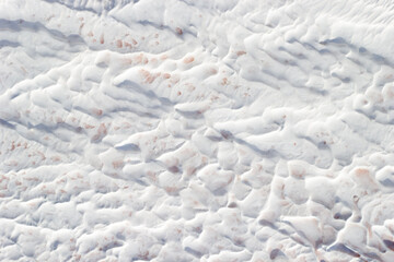 Background white and grey texture of Pamukkale calcium travertine in Turkey, abstract pattern, top view.