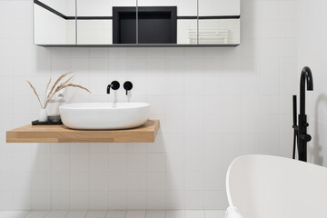 Bathroom washbasin on wooden shelf