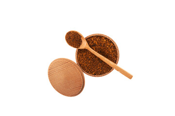 Chaga tea powder in wooden bowl with spoon on white background, top view. Dried pieces of birch chaga mushroom are used in alternative medicine