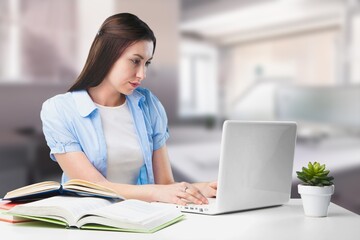 Relaxed female freelancer relaxing sitting in front of laptop, working or studying remotely from home, taking a break