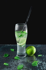 Mojito cocktail with lime, lemon and mint in a glass. Freshness cocktail