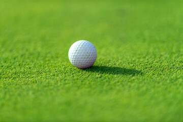 Golf ball on green grass of golf course. Horizontal sport theme poster, greeting cards, headers, website and app