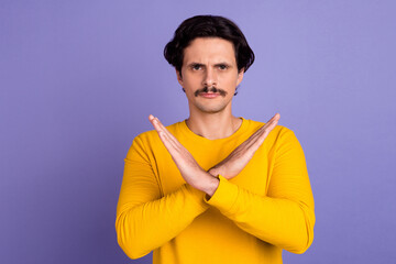 Photo of confident focused young man crossed arms demonstrate stop symbol isolated on violet color background