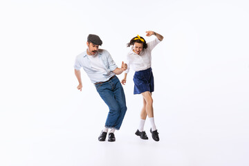 Portrait of beautiful couple, man and woman, dancing swing isolated over white studio background. Retro style