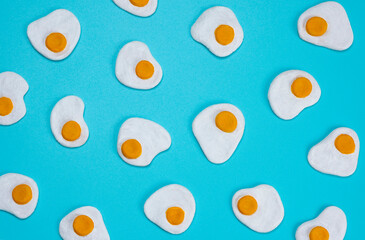 background of scrambled eggs on a blue background, close-up top view