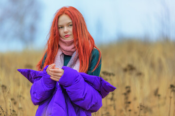 Teen girl in violet jacket in autumn day - 515173028