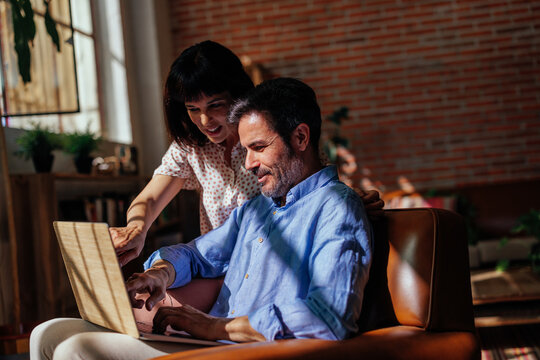 Mature Couple Looking Travel Destination On Laptop