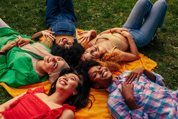 Girls lying in circle on lawn