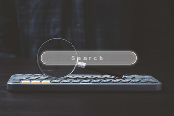 Magnifier glass on computer keyboard with search engine bar for SEO or Search Engine Optimisation...