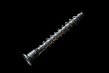 Metal spiral screw on isolated black background. Stainless steel bolt. Fixing tool for carpentry or...