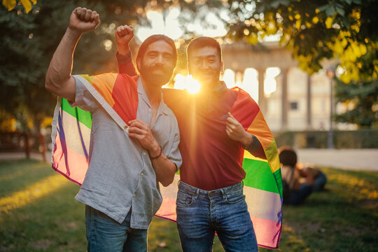 Same sex couple with pride flag outdoors