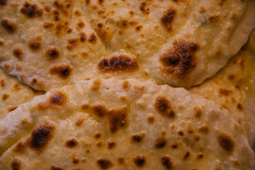 The texture of the dough. Puff pastry pie with meat filling close-up. Fresh pasties, fried bread with meat. A delicious snack or a nutritious lunch on the run. The concept of takeaway food.