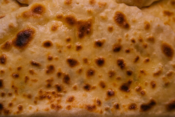 The texture of the dough. Puff pastry pie with meat filling close-up. Fresh pasties, fried bread with meat. A delicious snack or a nutritious lunch on the run. The concept of takeaway food.