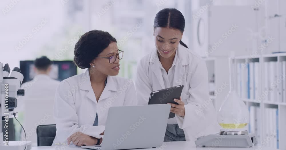 Poster two scientists high five while using a digital tablet in a laboratory. happy female doctors celebrat