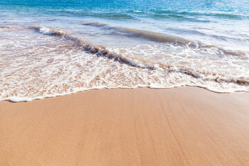 Maui Hawaii beach coastline of sand, sun, and blue water with crashing