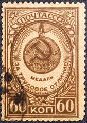 USSR - CIRCA 1946: A Stamp printed in the USSR shows the medal for labour difference it is founded 27 XII 1938 , circa 1946