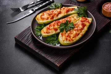 Baked stuffed zucchini boats with minced chicken mushrooms and vegetables with cheese