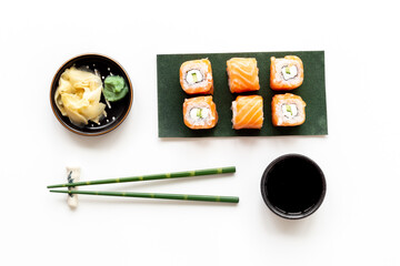 Sushi rolls set with salmon on green papper plate