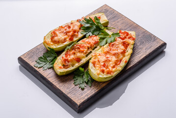 Baked stuffed zucchini boats with minced chicken mushrooms and vegetables with cheese