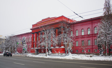 Main red building of National Taras Shevchenko University at winter in Kyiv, Ukraine - obrazy, fototapety, plakaty