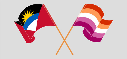 Obraz premium Crossed and waving flags of Antigua and Barbuda and Lesbian Pride