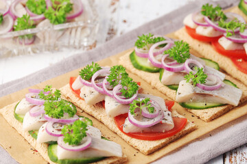 Sandwiches with herring and vegetables