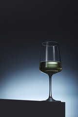 White wine in a transparent glass in low key