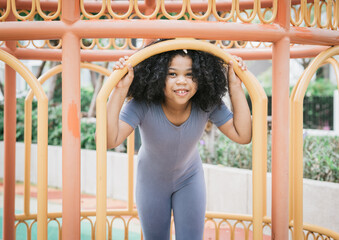 Obraz premium African girl smiling while playing at playground