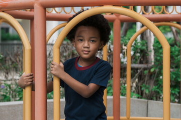 Fototapeta na wymiar African kid smiling while playing at playground