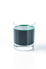 Spirulina drink in a glass on a white background.