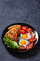 irish breakfast of fried eggs, bacon, potato farls