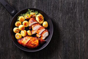 grilled chicken breasts with browned new potatoes