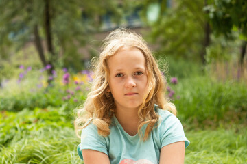 Portrait of a little cheerful girl in a T-shirt.