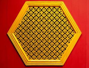 Gold Hexagon stencil window on the wood red wall Chinese style