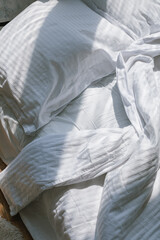 Sun rays on beautiful bed linen in the morning. Close up, mock up. Bed room.