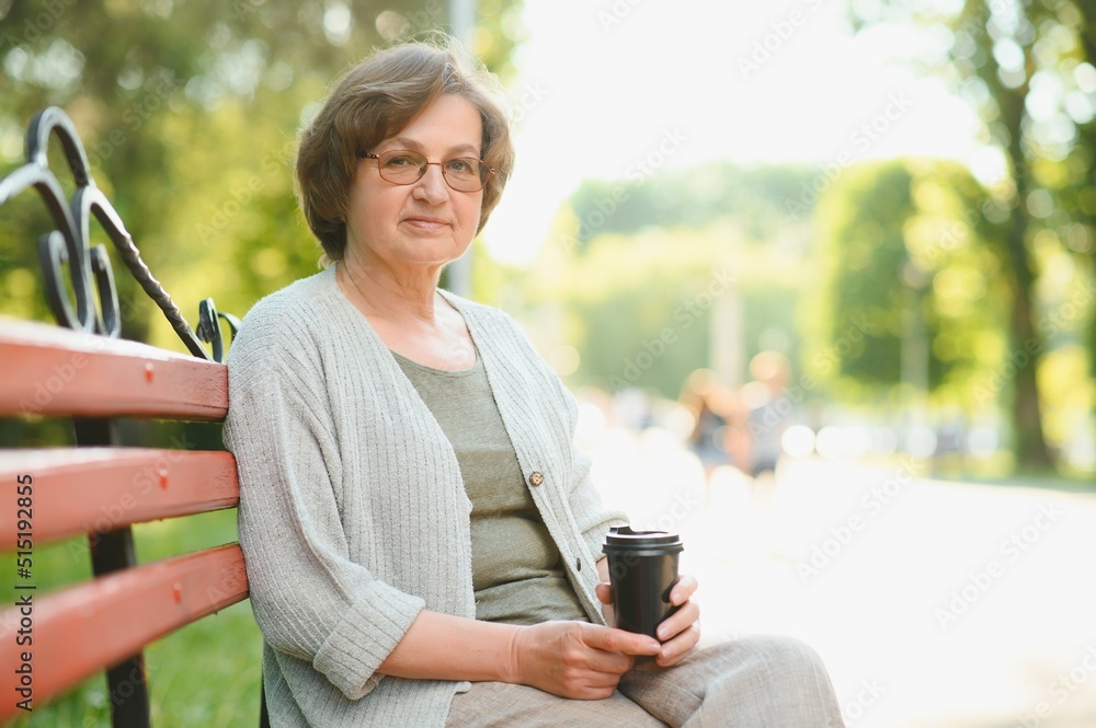 Sticker Portrait of a happy Senior woman in summer park