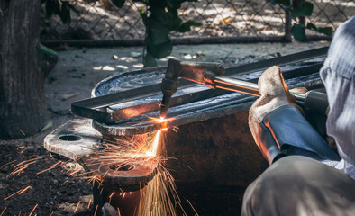 Close up hand heavy industrial worker is working on metal work factory process by Cutting sheet...