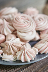 pink and white meringues on a plate of different shapes