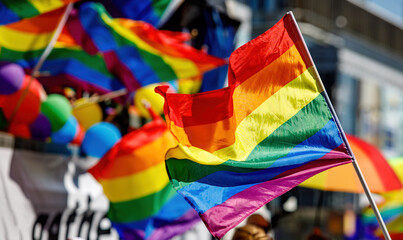 Lgbt pride rainbow flag during parade in the city . - obrazy, fototapety, plakaty