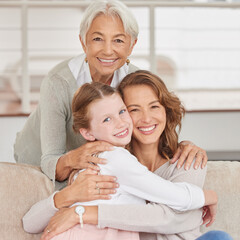 Portrait of a grandmother relaxing with her daughter and mother. Little girl bonding with her...